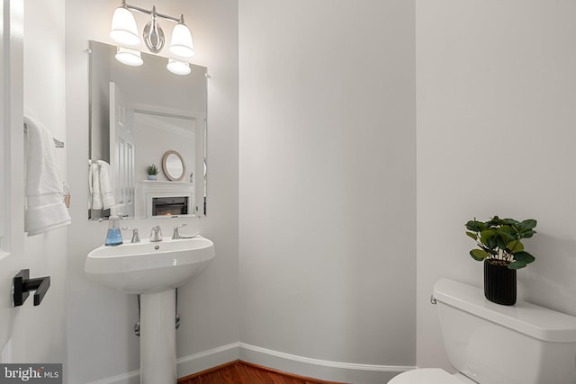 bathroom with toilet and baseboards