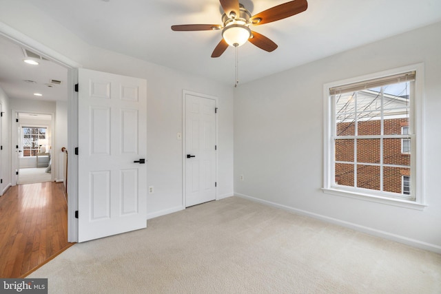 unfurnished bedroom with recessed lighting, light colored carpet, ceiling fan, and baseboards