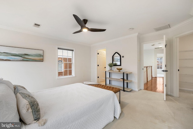 bedroom featuring baseboards, visible vents, ornamental molding, and light colored carpet