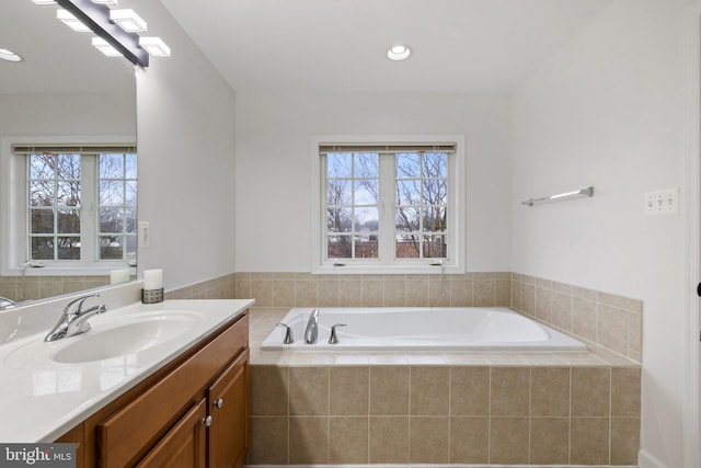 full bath with a garden tub, vanity, a wealth of natural light, and recessed lighting