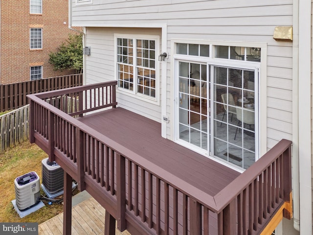 wooden terrace featuring central AC and fence