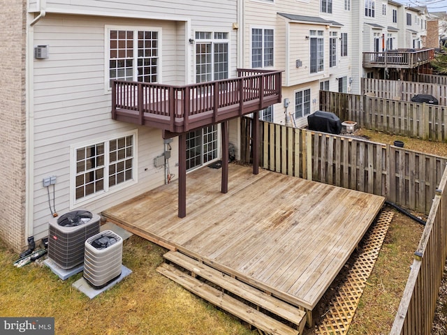 deck with fence, grilling area, and central AC