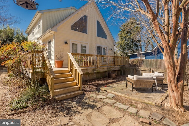 rear view of property with a patio, a deck, and fence