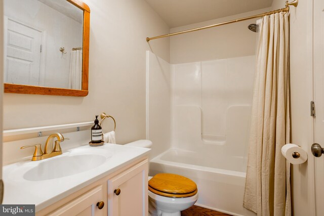 full bathroom featuring vanity, shower / tub combo, and toilet