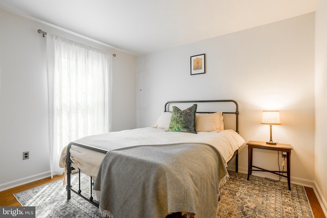 bedroom featuring wood finished floors and baseboards