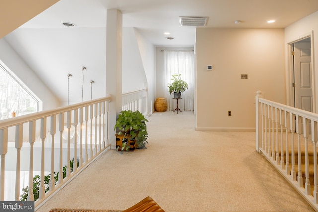 corridor with carpet flooring, recessed lighting, visible vents, and baseboards