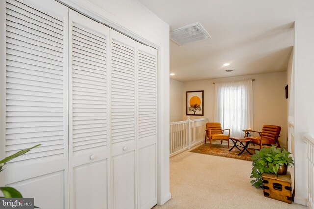 corridor with recessed lighting, visible vents, and carpet flooring