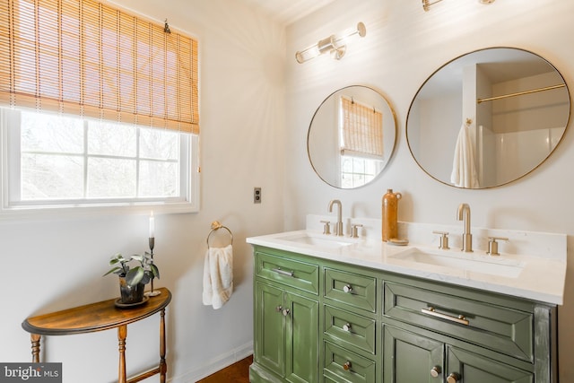 full bath with double vanity and a sink