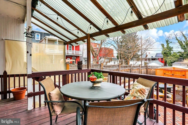 deck with outdoor dining space and a fenced backyard