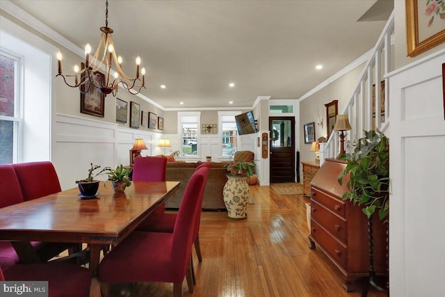 dining space with ornamental molding, stairway, recessed lighting, and a decorative wall