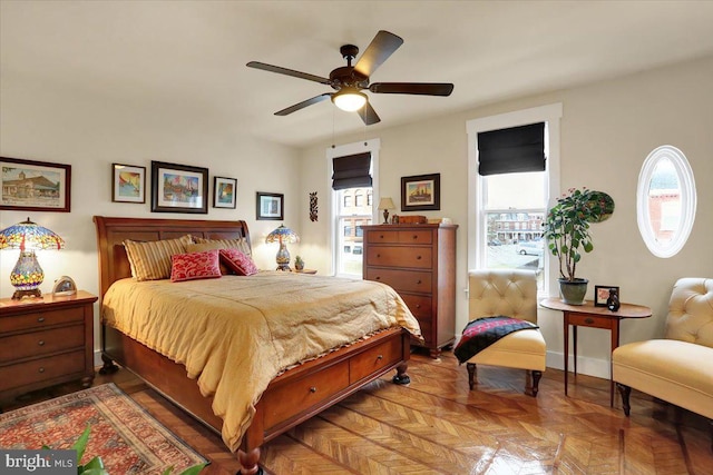 bedroom with ceiling fan and baseboards