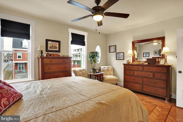 bedroom featuring a ceiling fan and baseboards