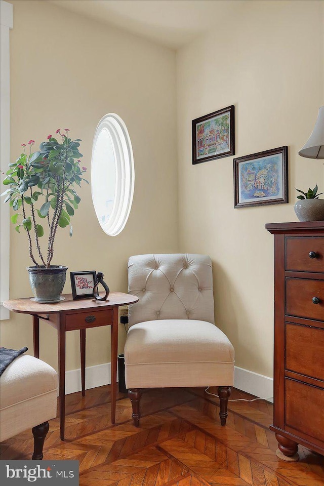 living area featuring baseboards