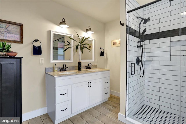 bathroom with a stall shower, a sink, and wood tiled floor