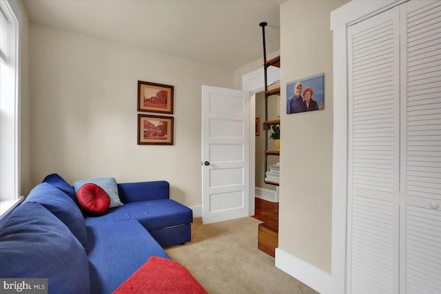 living room featuring carpet floors and baseboards