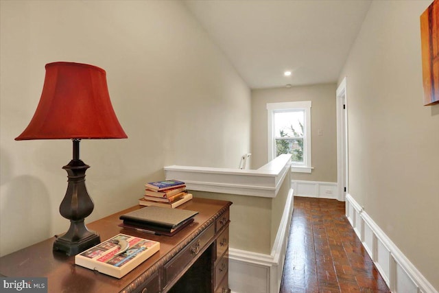 hall with brick floor and an upstairs landing