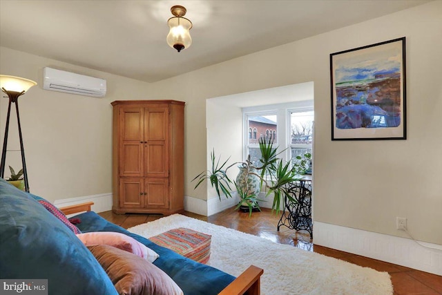 living area featuring baseboards and a wall mounted air conditioner