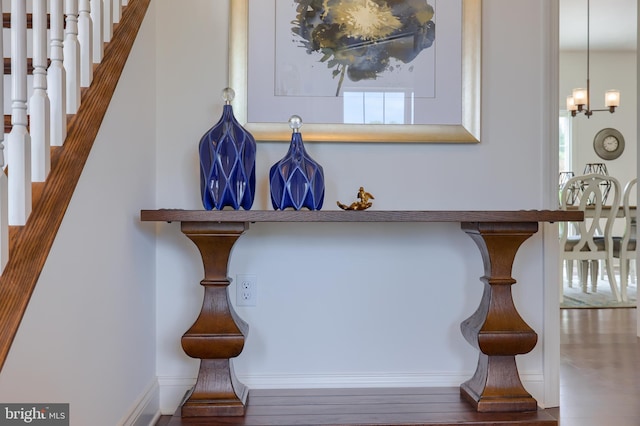 interior details featuring an inviting chandelier and wood finished floors