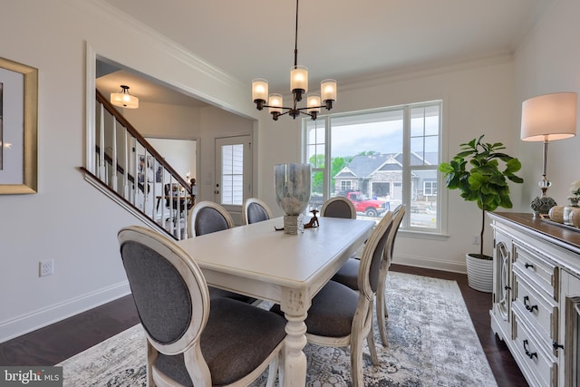 dining room featuring baseboards, dark wood finished floors, and crown molding