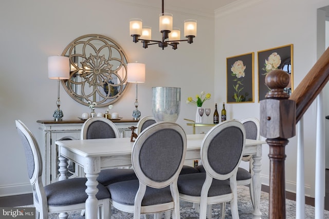 dining space with a chandelier, ornamental molding, baseboards, and wood finished floors