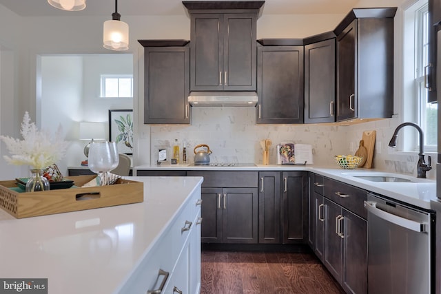 kitchen featuring black electric stovetop, under cabinet range hood, a sink, light countertops, and dishwasher