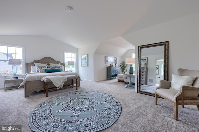 bedroom with lofted ceiling, baseboards, visible vents, and carpet