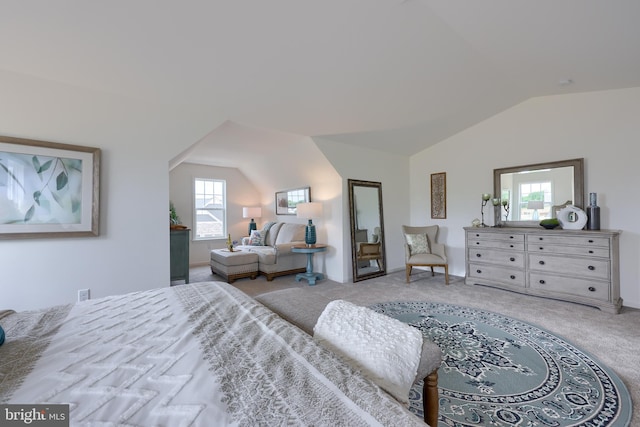 carpeted bedroom featuring lofted ceiling