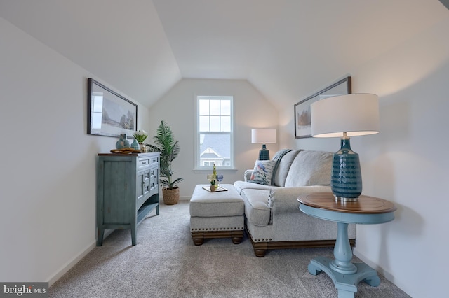 sitting room with lofted ceiling, baseboards, and carpet flooring