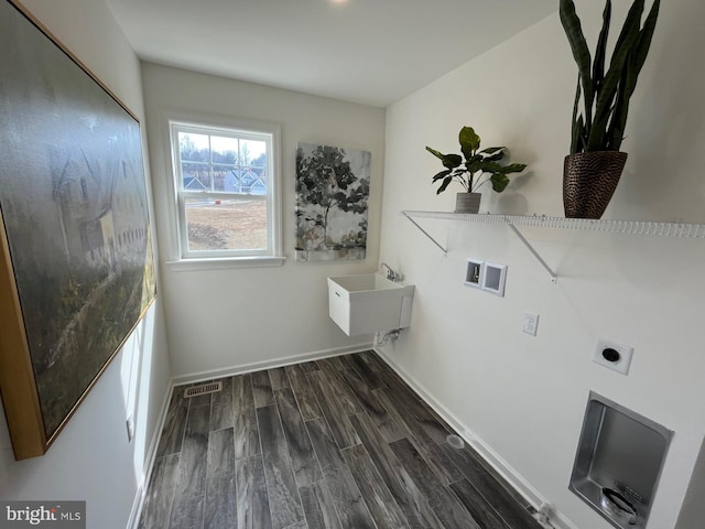 laundry area with laundry area, baseboards, visible vents, dark wood-style floors, and electric dryer hookup