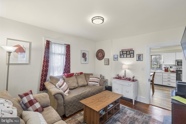 living room with plenty of natural light and wood finished floors