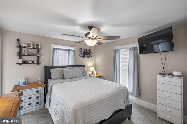 carpeted bedroom featuring ceiling fan and baseboards