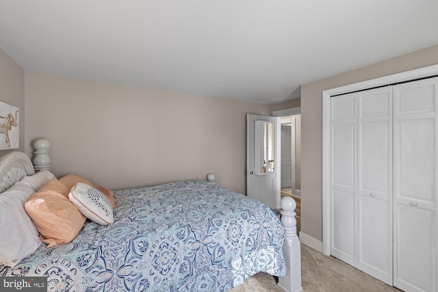 bedroom featuring a closet and light colored carpet