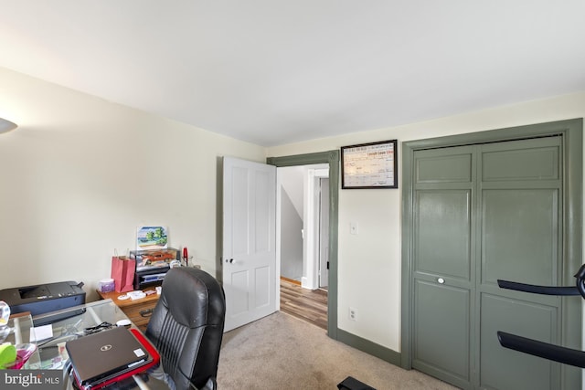 home office featuring light carpet and baseboards