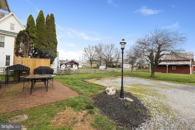 view of yard with fence and a patio