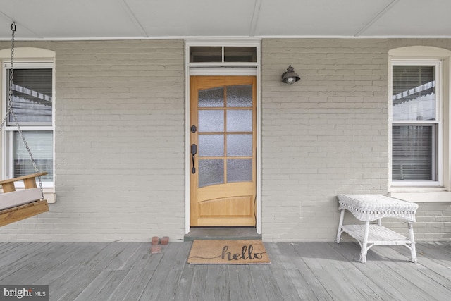 entrance to property featuring brick siding