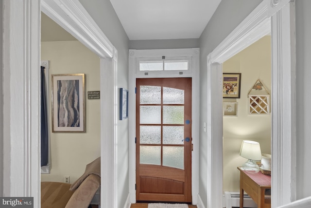 doorway to outside featuring baseboard heating