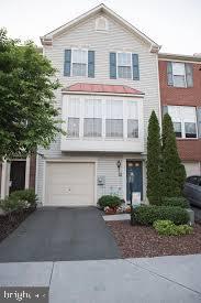 view of front of home with aphalt driveway, a balcony, and an attached garage