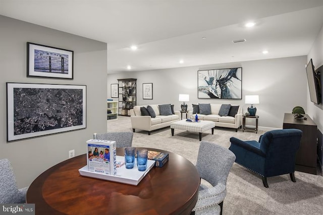 living area with carpet and recessed lighting