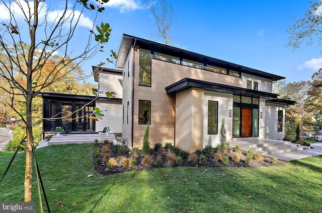 exterior space featuring a front yard and brick siding