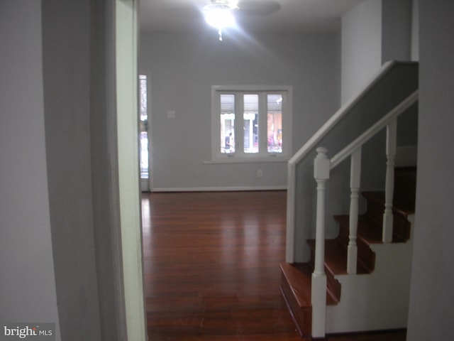 foyer entrance featuring stairs, ceiling fan, wood finished floors, and baseboards