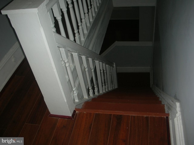 staircase featuring wood finished floors