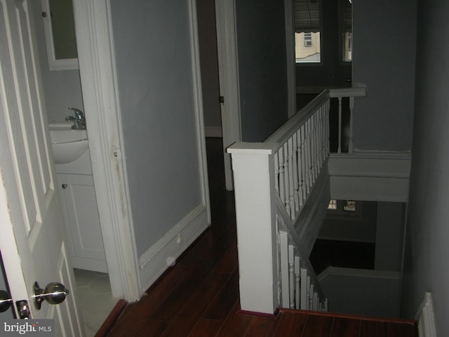 stairway with wood finished floors