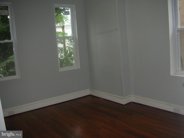 empty room with dark wood-style floors