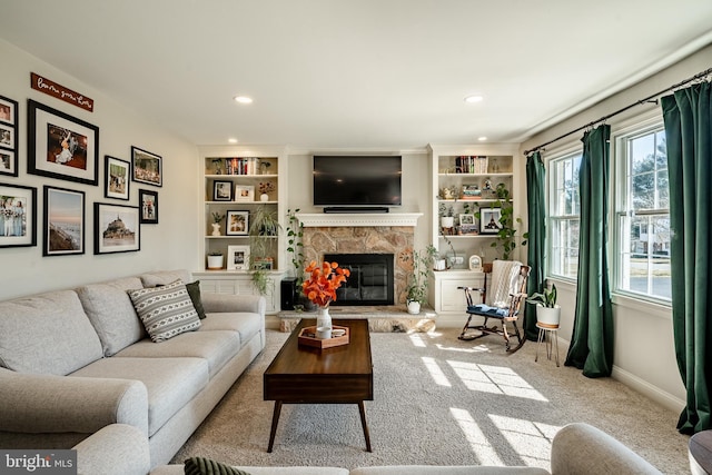 living area with built in features, recessed lighting, carpet, a stone fireplace, and baseboards