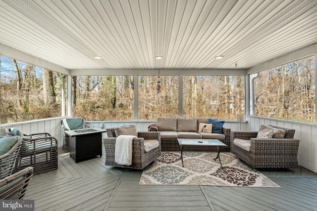 sunroom / solarium featuring plenty of natural light and wood ceiling