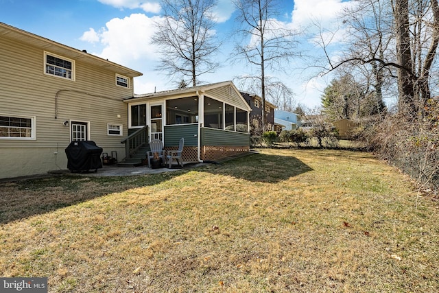 back of property with a patio, a yard, and a sunroom