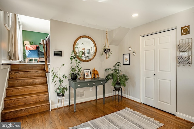 entryway featuring stairs, recessed lighting, wood finished floors, and baseboards