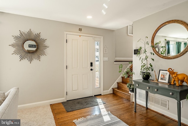 entryway featuring visible vents, wood finished floors, recessed lighting, stairway, and baseboards