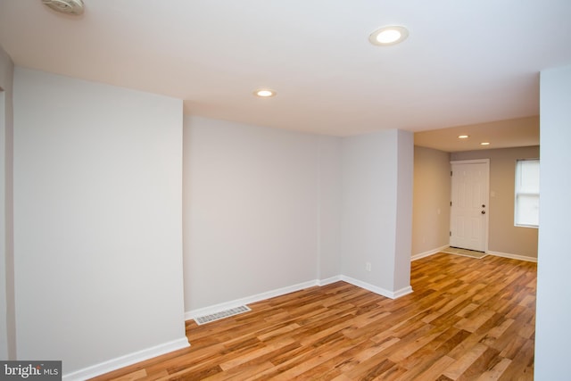 spare room with baseboards, light wood finished floors, visible vents, and recessed lighting