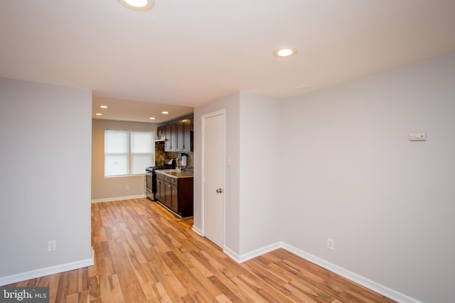 interior space featuring stainless steel gas stove, recessed lighting, light wood-type flooring, and baseboards